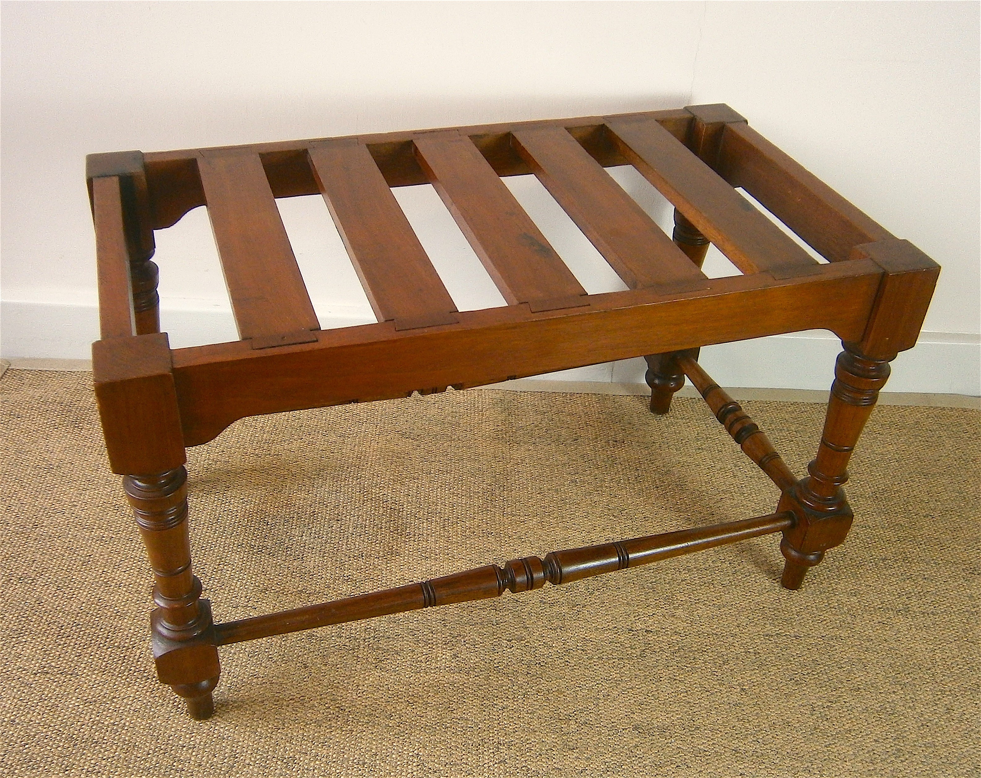 A late Victorian aesthetic movement walnut luggage stand, length 69cm, depth 38cm, height 41cm